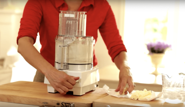 butter is added to a food processor for pie dough