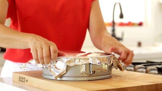 Placing foil on cheesecake pan