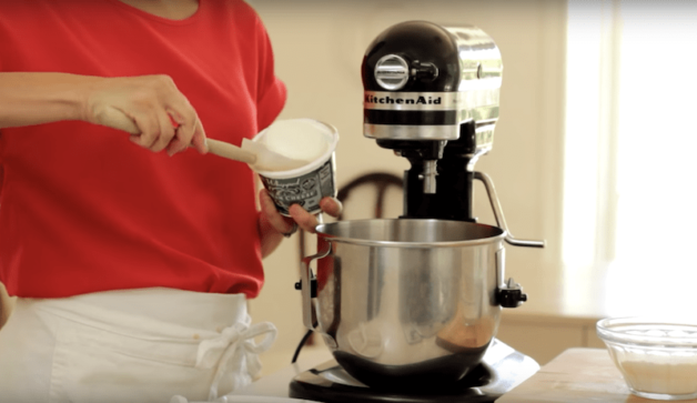 cream cheese added to a bowl of a stand mixer 