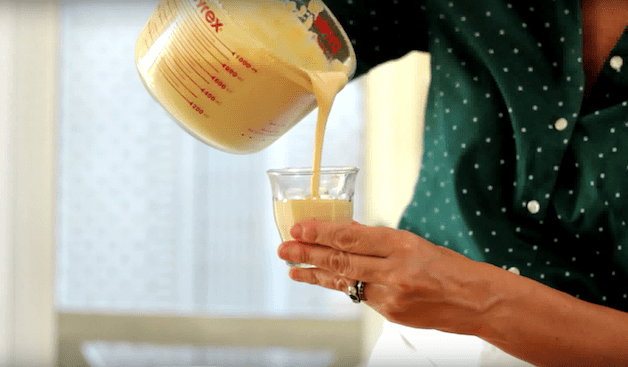 salted caramel pudding being poured into little glass cups