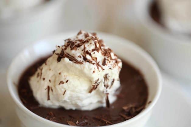 Chocolate Pot de Creme in a white ramekin with whipped cream on top
