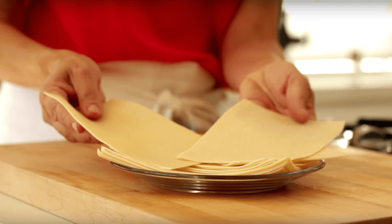 A person holding Fresh Lasagna Sheets on a plate