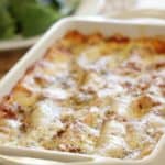 Lasagna in a large white baking casserole on table