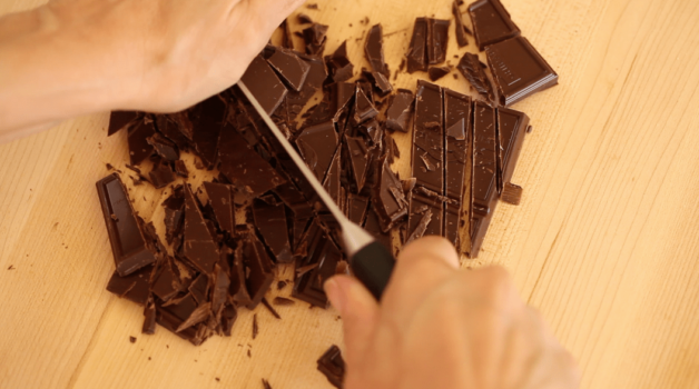 Chopping chocolate for a Chocolate Pot de Creme Recipe