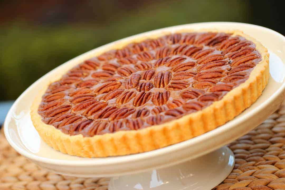 Chocolate Pecan Pie on a white cake stand