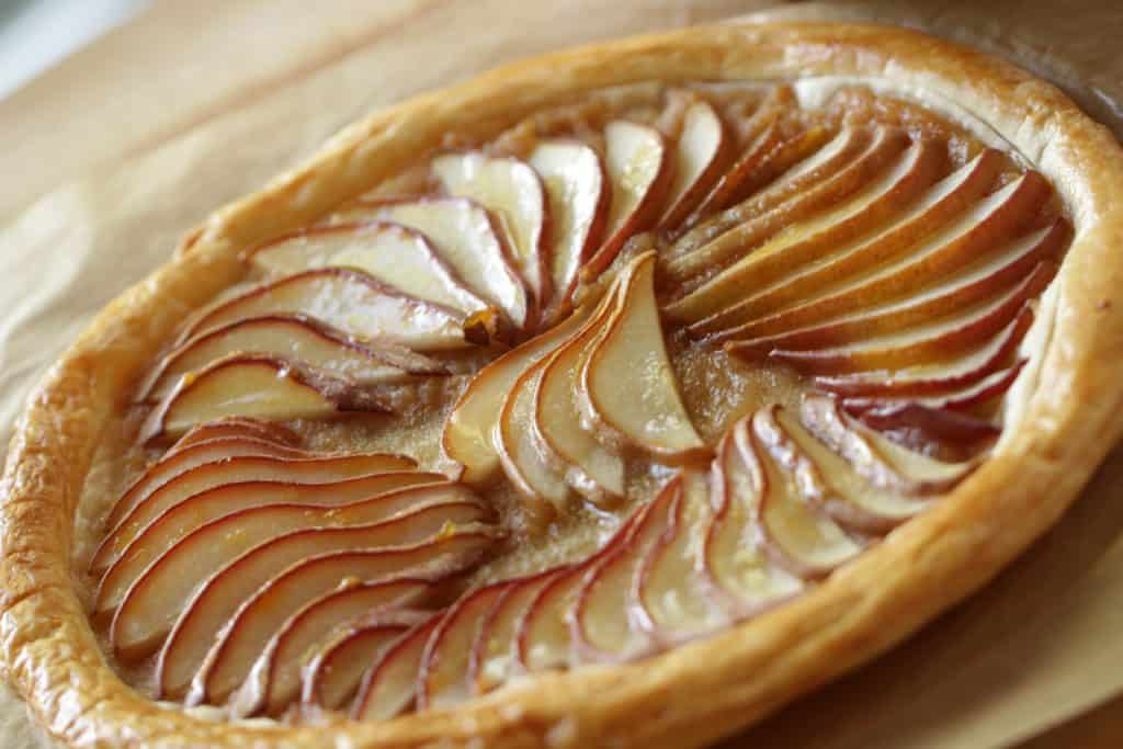 Easy Pear Tart Recipe served on a wooden cutting board