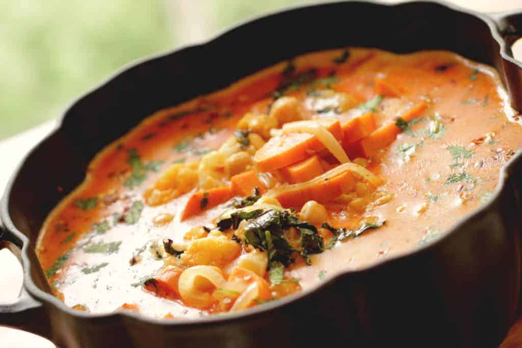 Vegetarian Thai Red Curry served in a black pumpkin shaped pot