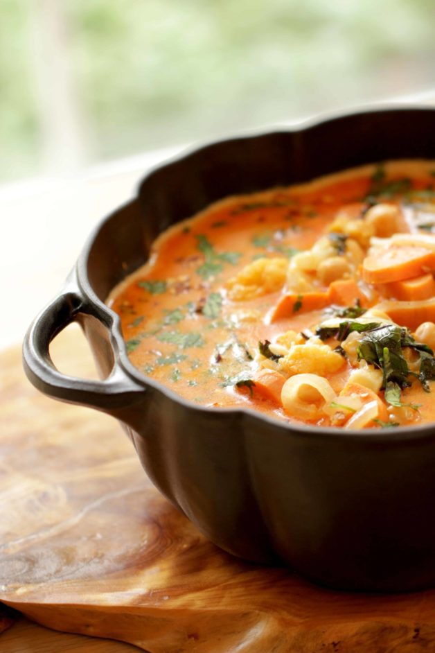 close up of Vegetarian Thai Red Curry served in a black pumpkin shaped pot