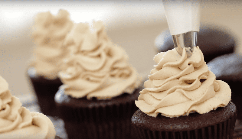 frosting is piped on top of a Cafe Mocha Cupcake