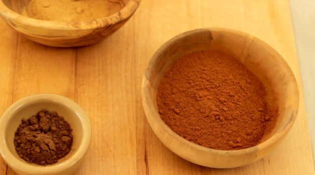 Spices in bowls on a cutting board for pumpkin pie spice