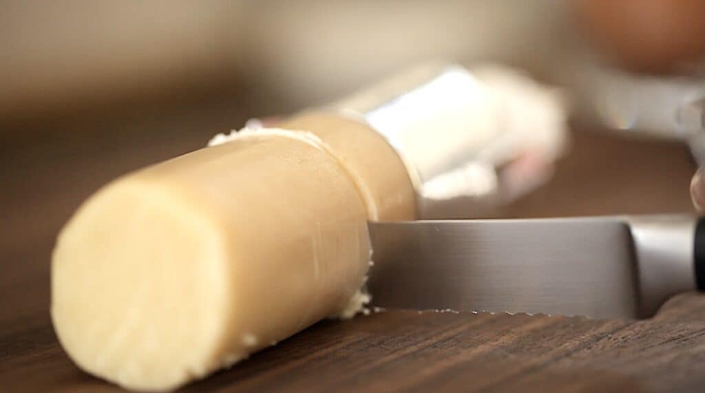 Slicing almond paste with a serrated knife