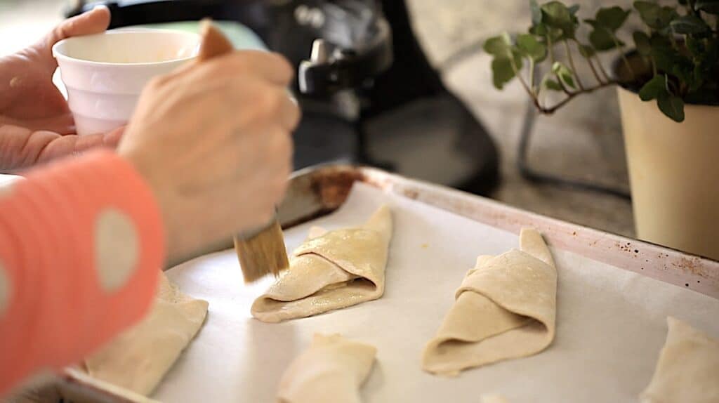 brushing puff pastry with egg wash