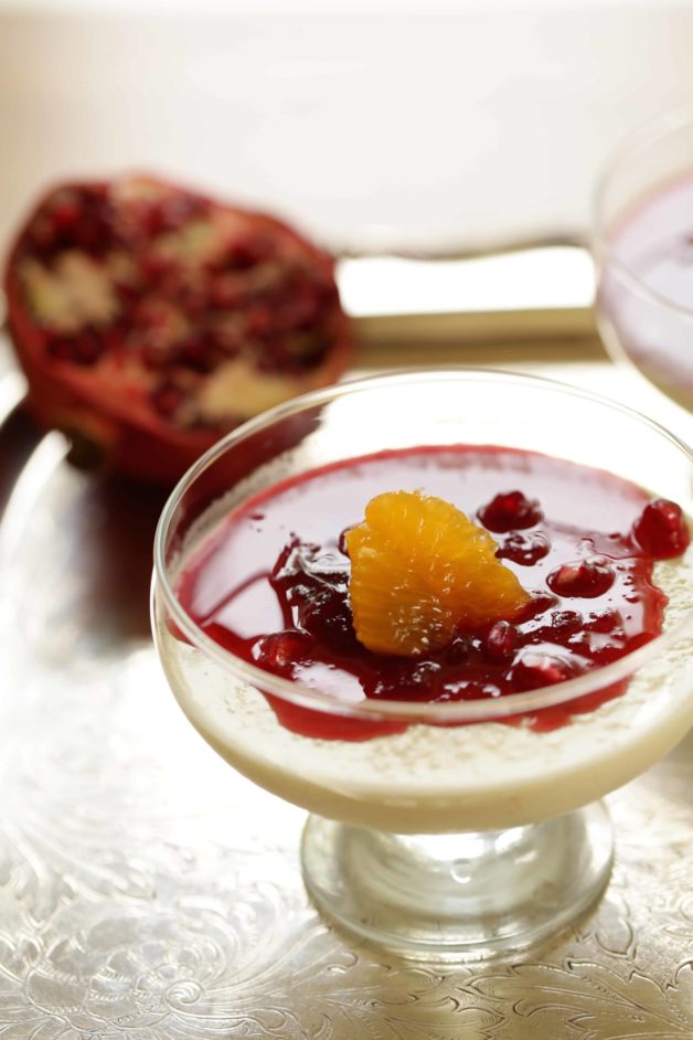 up close of a cranberry panna cotta in a glass dish 