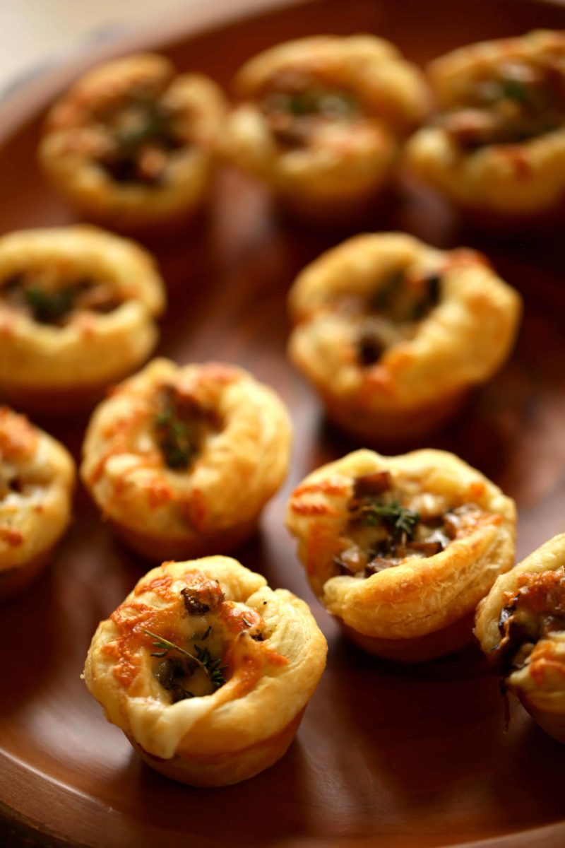 Mushroom Tarts made with puff pastry on a wooden platter