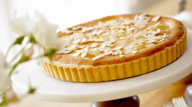 Pear and Almond Tart Recipe served on a white cake stand