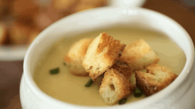 Potato Leek Soup-No Cream recipe served in a small white bowl with croutons on top
