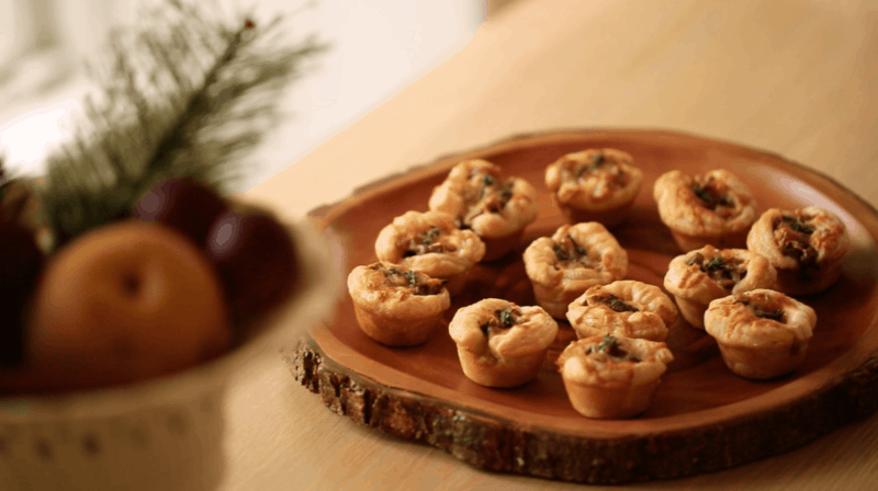 Mini Mushroom Tartlets on a wooden platter on a table