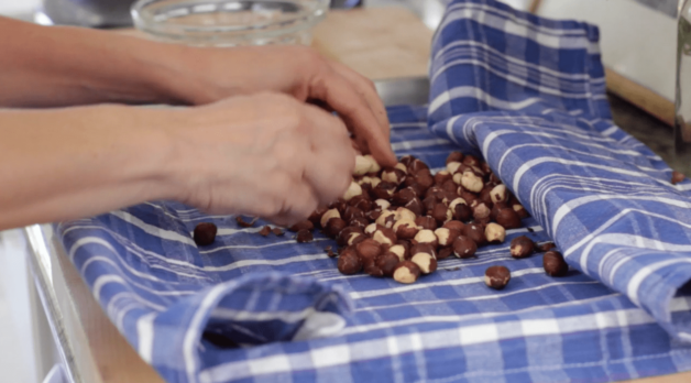peeling skins off roasted hazelnuts on a dish towel