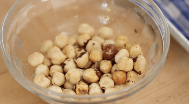 toasted hazelnuts without the skin in a small clear bowl 