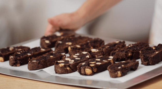 Biscotti slices placed on a parchment-lined baking sheet 