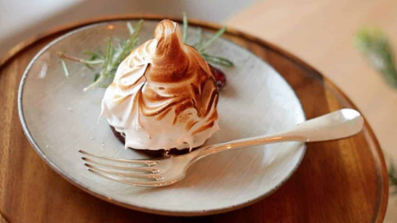 Holiday Baked Alaska on a gray plate with a fork