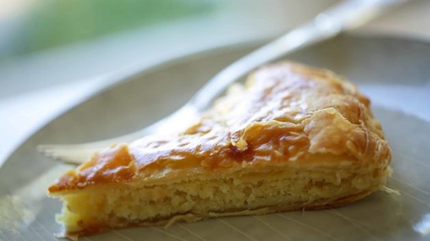 a slice of Galette des Rois cake on a plate with fork