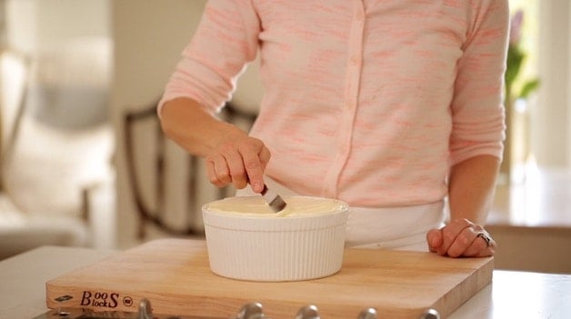 leveling off cheese souffle batter in a souffle dish