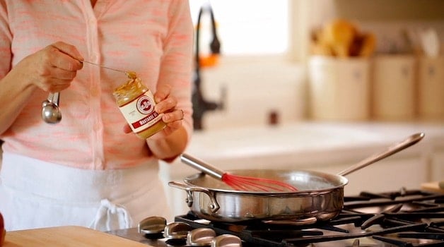 adding mustard to a skillet