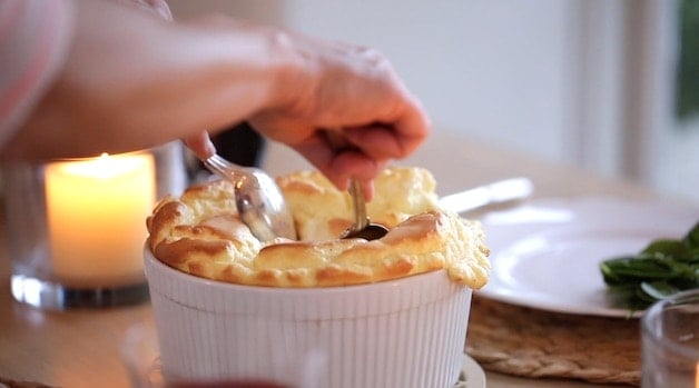 pulling apart a cheese souffle with 2 spoons