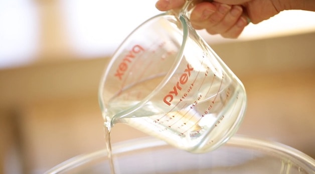 Adding water to a bowl from a Pyrex Pitcher