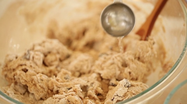 Adding water to dough in a bowl