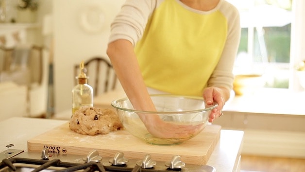 Greasing a bowl with olive oil