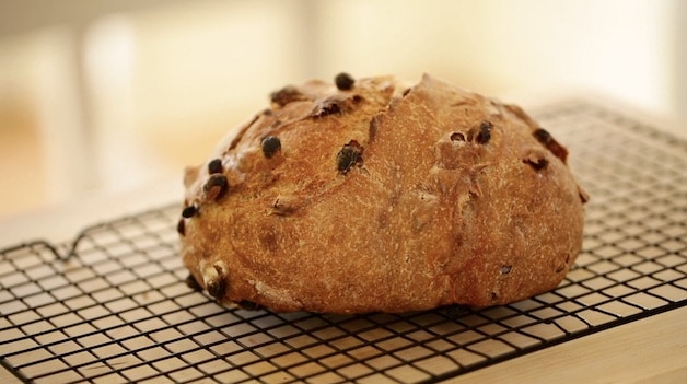 Side angle of bread loaf on a cooling rack