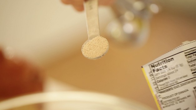 adding instant yeast to a bowl