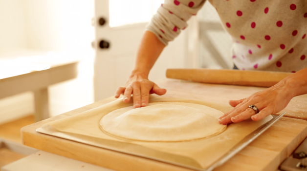 Sealing puff pastry round for a galette de rois cake