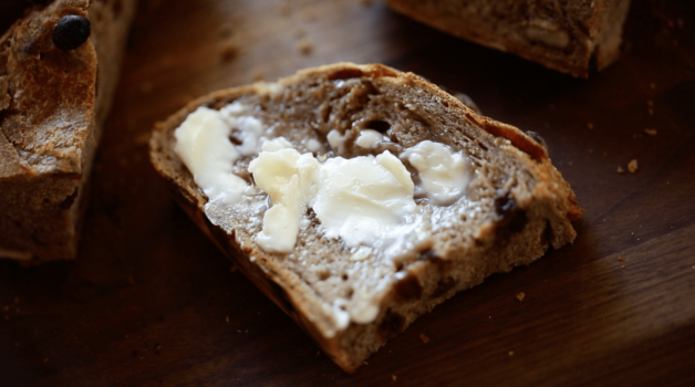 a slice of cinnamon raisin bread slathered with butter