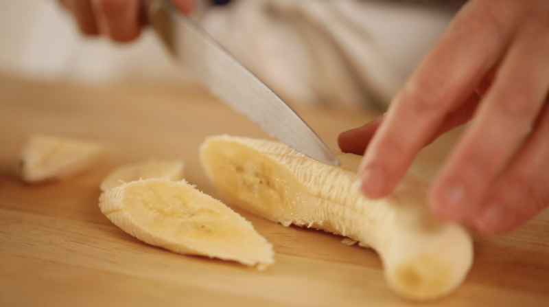 bananas sliced on a wood board for a banana pancake recipe