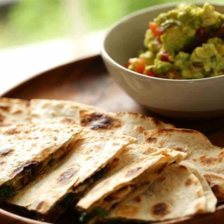 Veggie Quesadillas on a platter with Guacamole