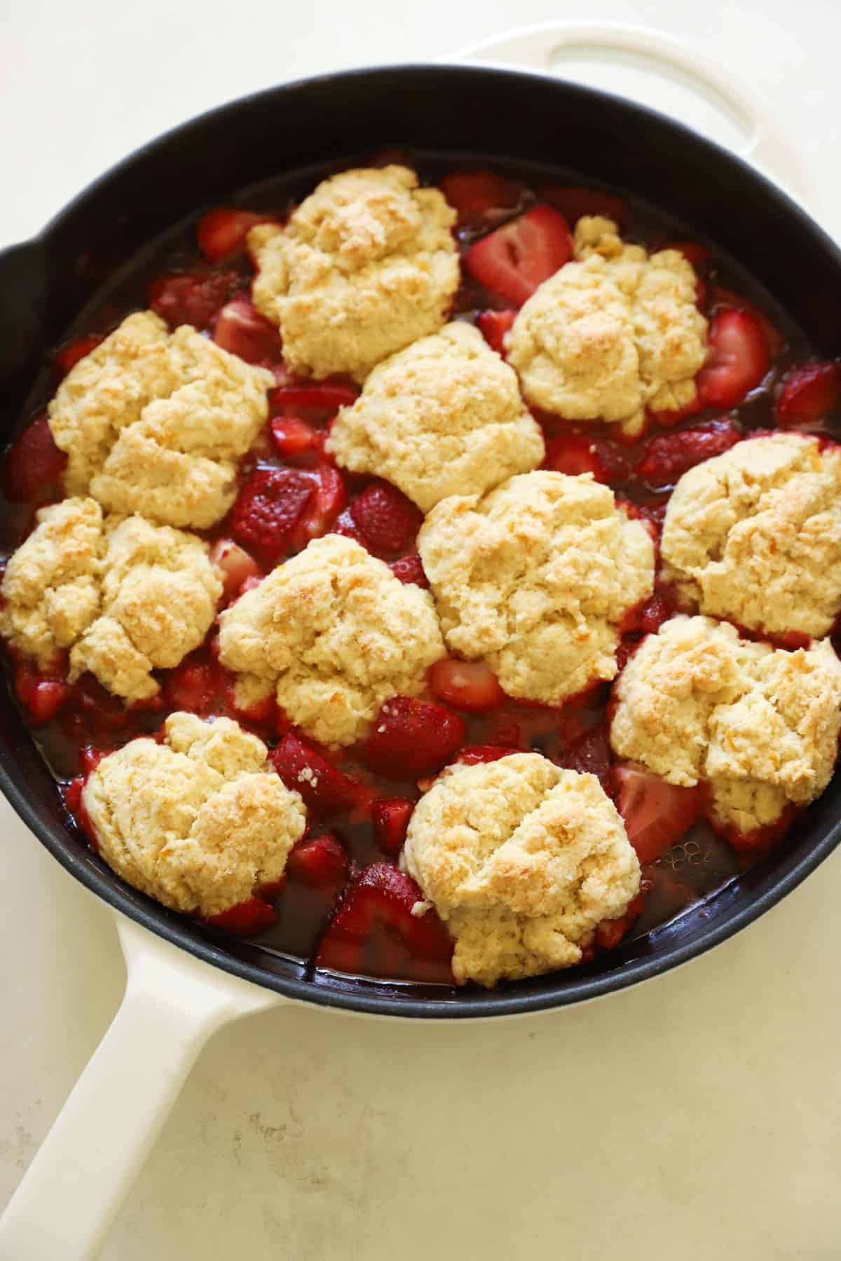 a bubbling cobbler in a cast-iron skillet out of the oven