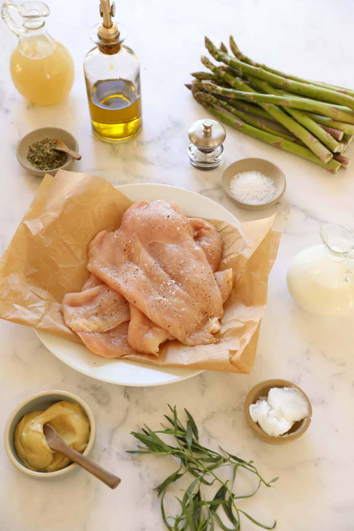 Chicken, Asparagus, Dijon Mustard, Heavy Cream, and Chicken Broth laid out on a counter