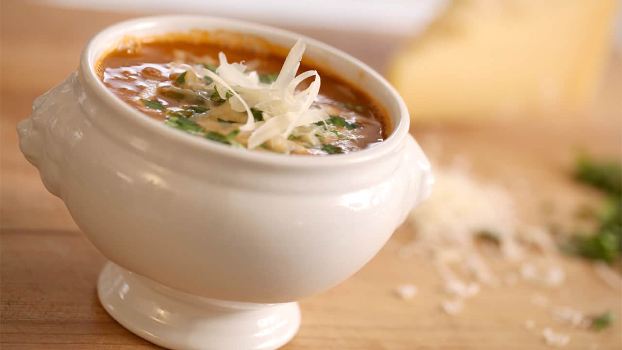 Minestrone Soup in a white Bowl with Parmesan CHeese