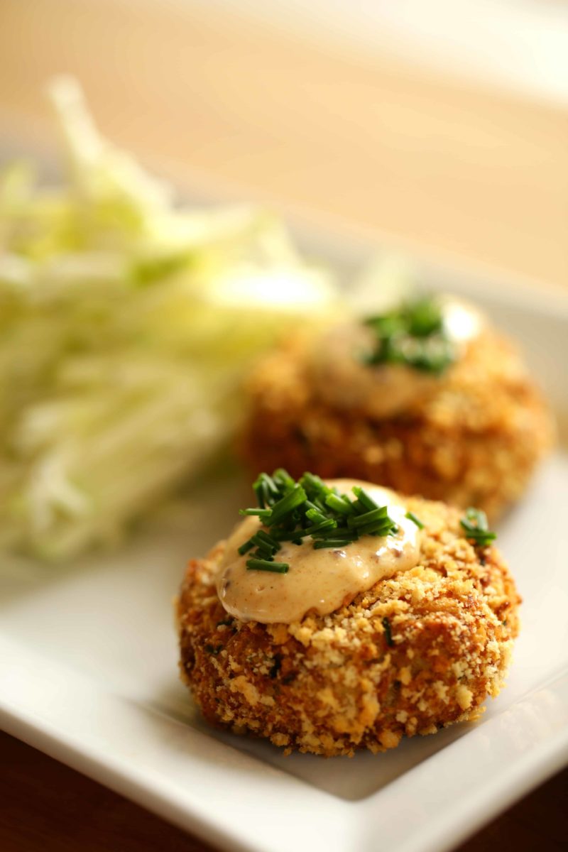  Easy Crab Cake Recipe served on a square white plate with apple slaw