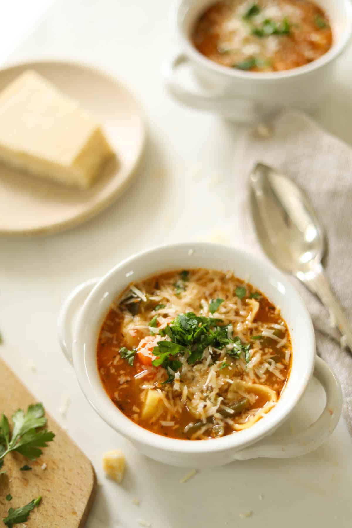 Two bowls of Minestrone Soup in white bowls.