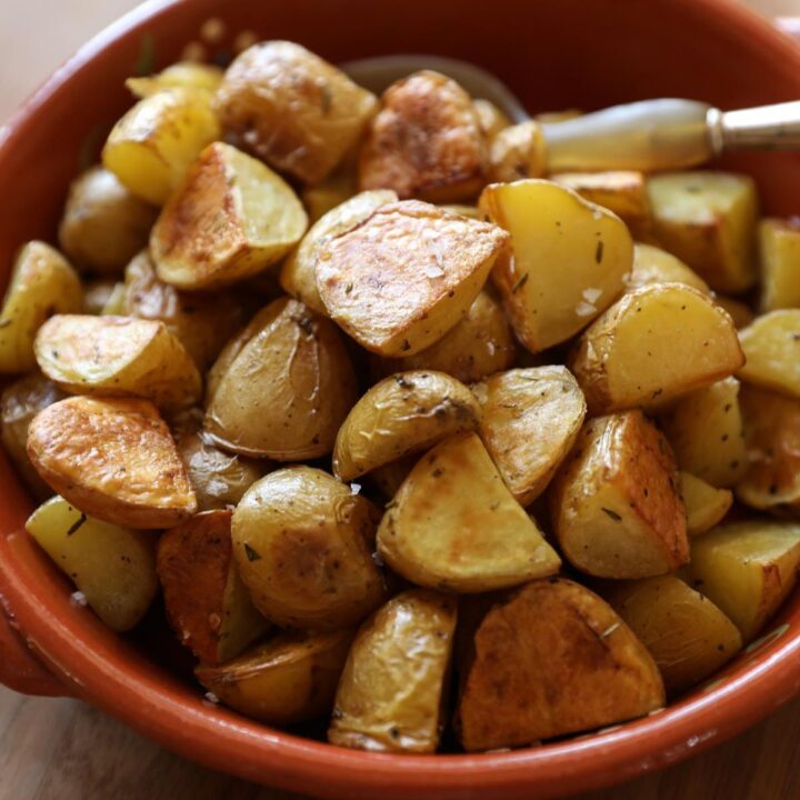 roasted potatoes in a terra cotta bowl