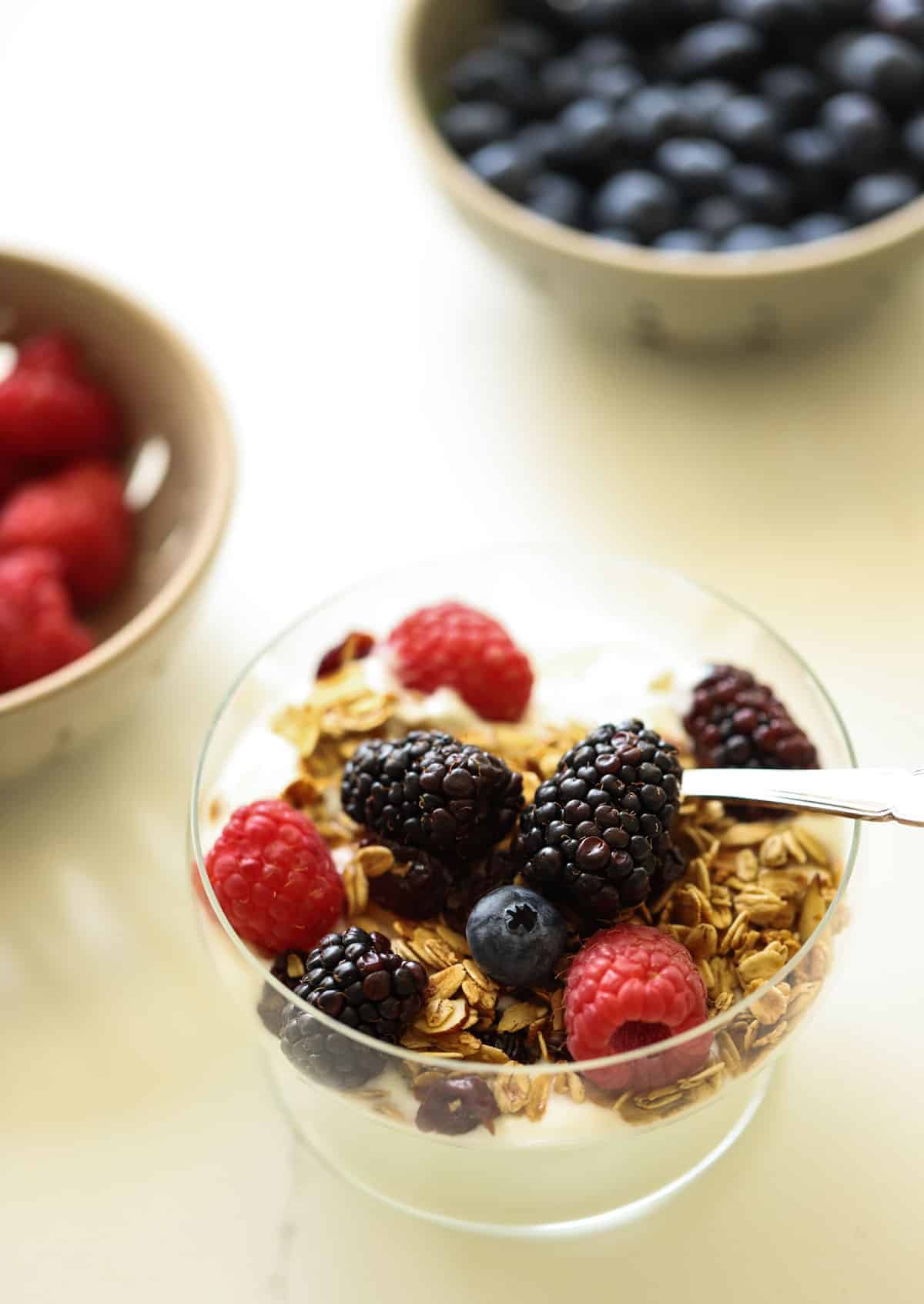 berries in bowl and a granola yogurt parfait recipe