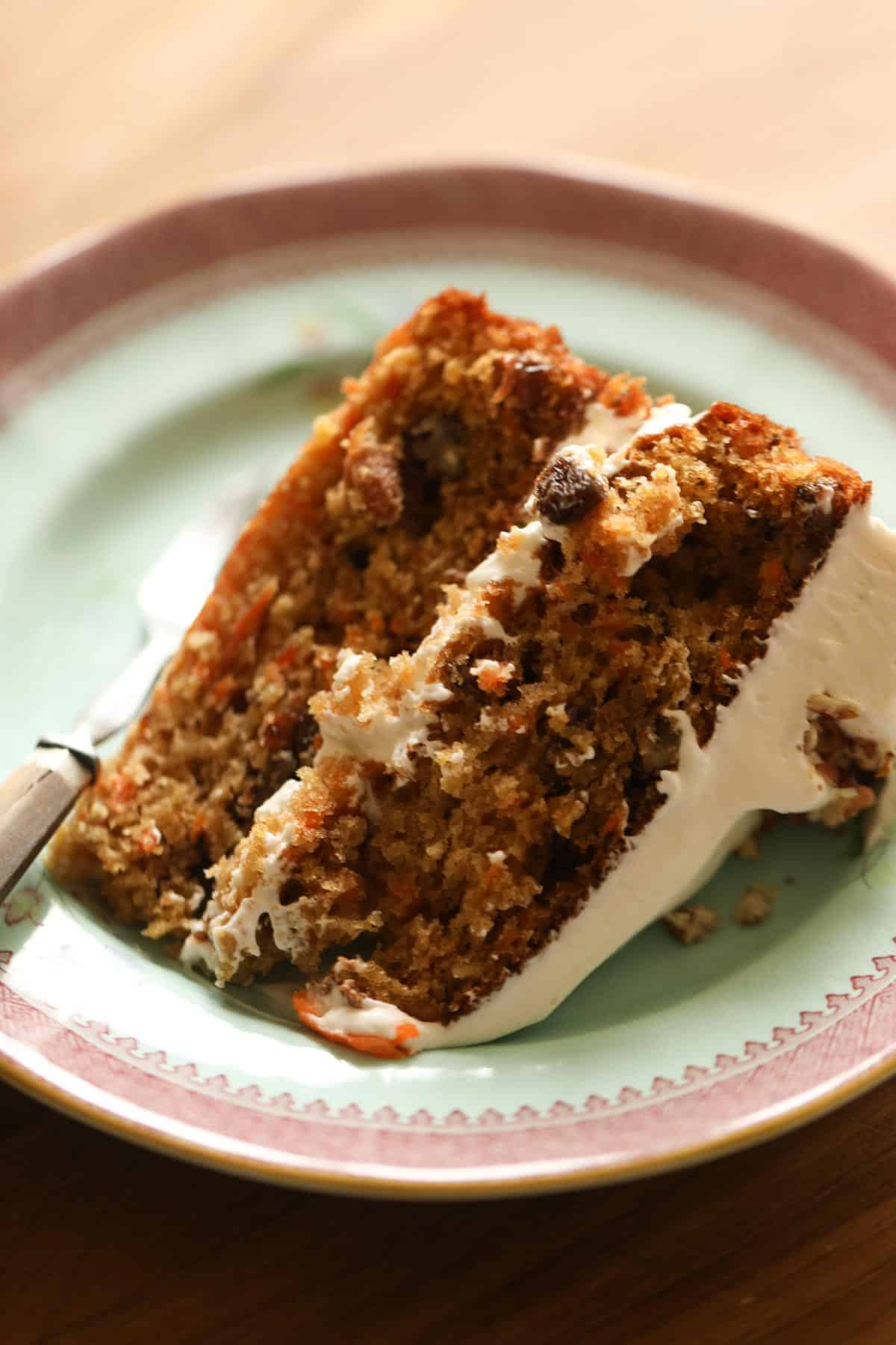 a slice of moist carrot cake with pineapple and raisins