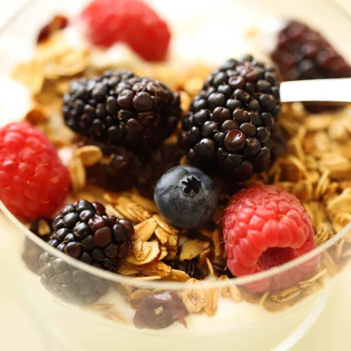 a yogurt parfait with granola and berries on top