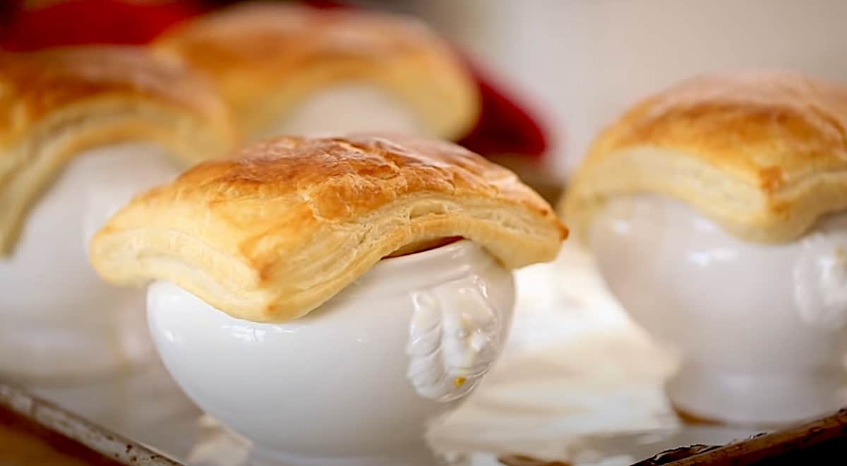 White lions head bowls covered with a square of baked puff pastry