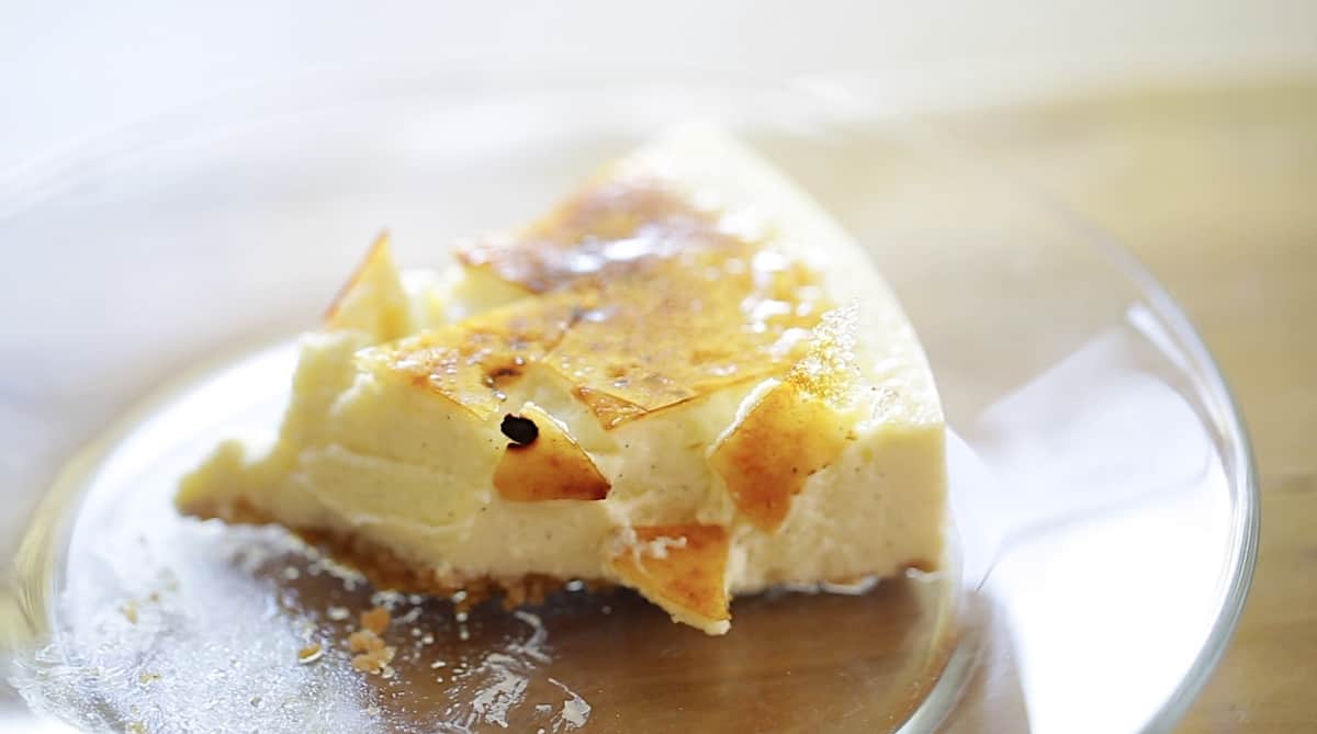 a slice of creme brulee cheesecake showing the crackling burnt sugar topping