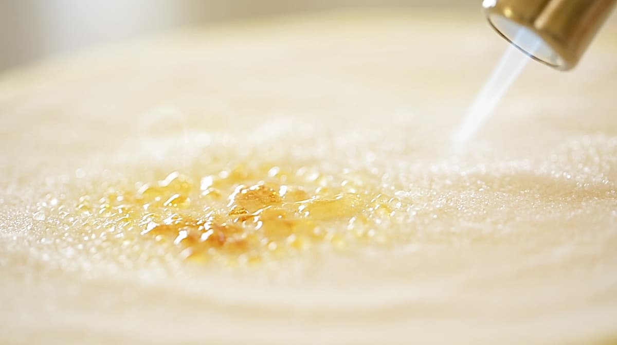 small bubbles of burnt sugar being created with a kitchen tork